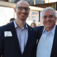 Two alumni pose for a photo together